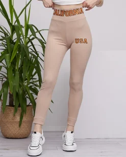 Royalfashion Beżowe damskie prążkowane legginsy z pomarańczowymi napisami