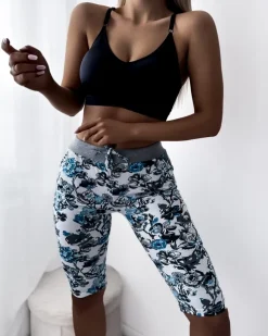 Royalfashion Damskie spodenki 3/4 w białym kolorze i w kwiaty