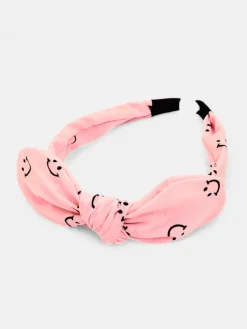 Royalfashion Dziecięca opaska do włosów z kokardką z printem w uśmiechnięte buźki