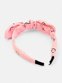 Royalfashion Dziecięca opaska do włosów z kokardką z printem w uśmiechnięte buźki