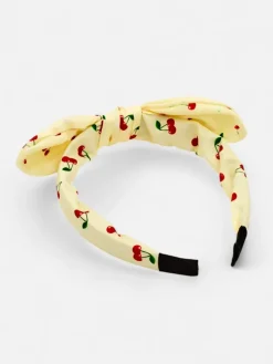 Royalfashion Dziecięca opaska do włosów z kokardką z printem w wisienki