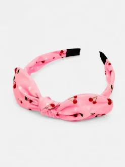 Royalfashion Dziecięca opaska do włosów z kokardką z printem w wisienki