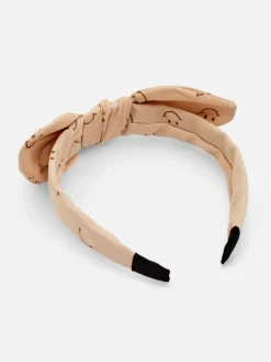 Royalfashion Dziecięca opaska do włosów z kokardką z printem w uśmiechnięte buźki